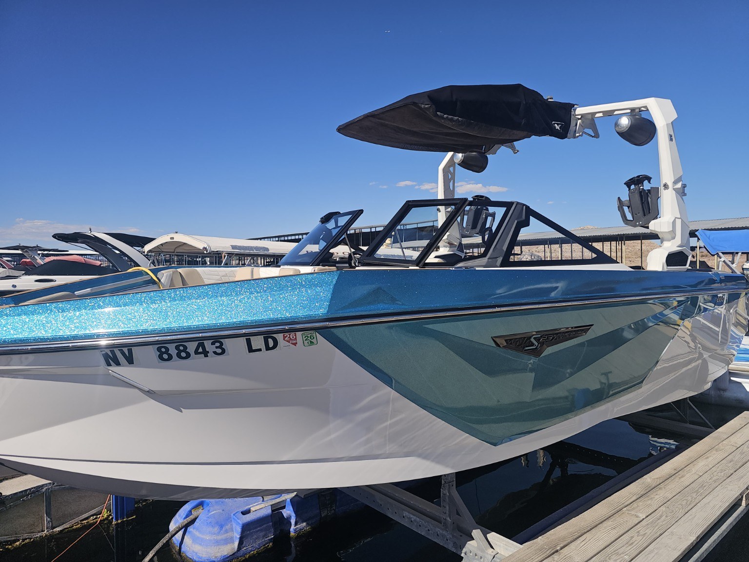 After detailing: blue and white boat with glossy hull and clear reflections at a Lake Mead marina