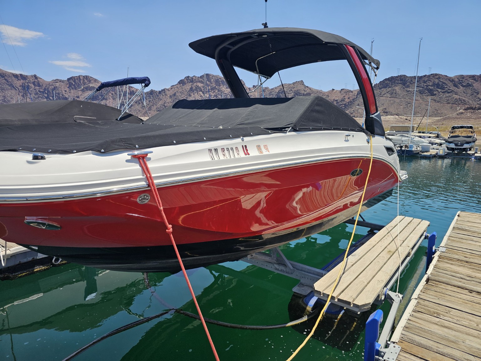Example of Lake Mead Detailing work on a red and white boat docked at a marina